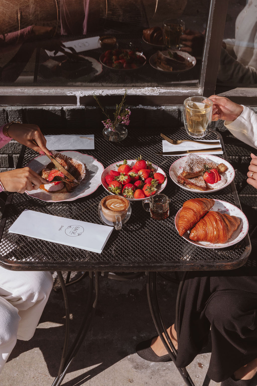 Friends sharing brunch on the patio at Sage