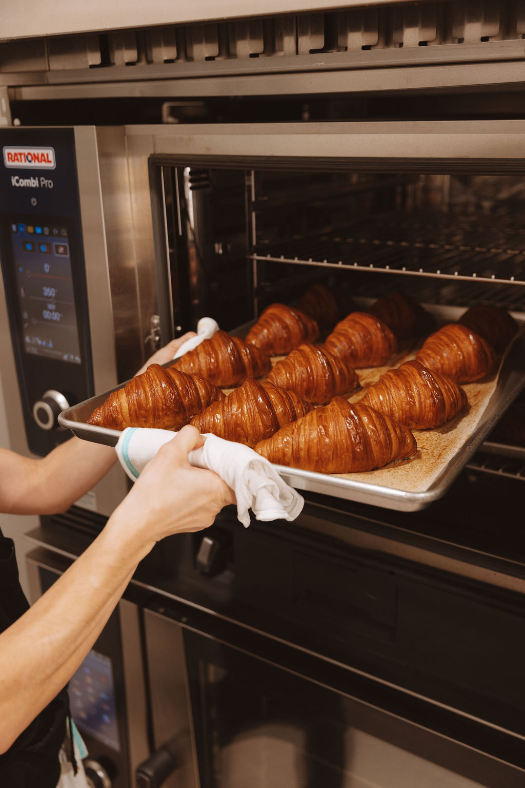 Pulling croissants from the oven
