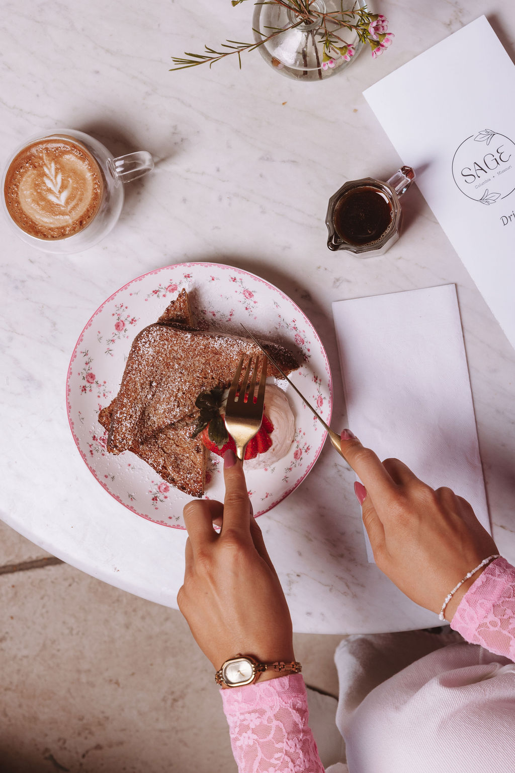 An overhead brunch moment — French toast and a latte at a marble table